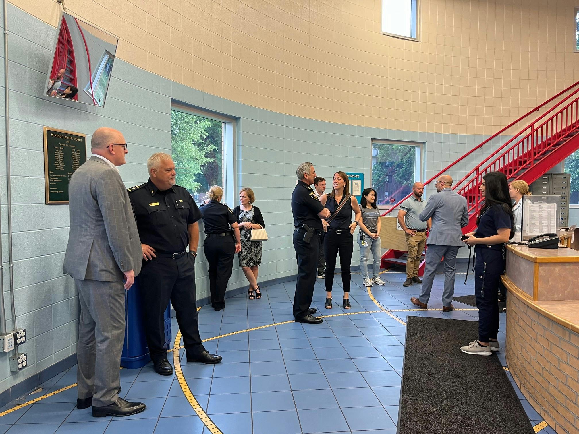 Mayor Drew Dilkens, Windsor Police, and other partners at the H4 building during a media event.