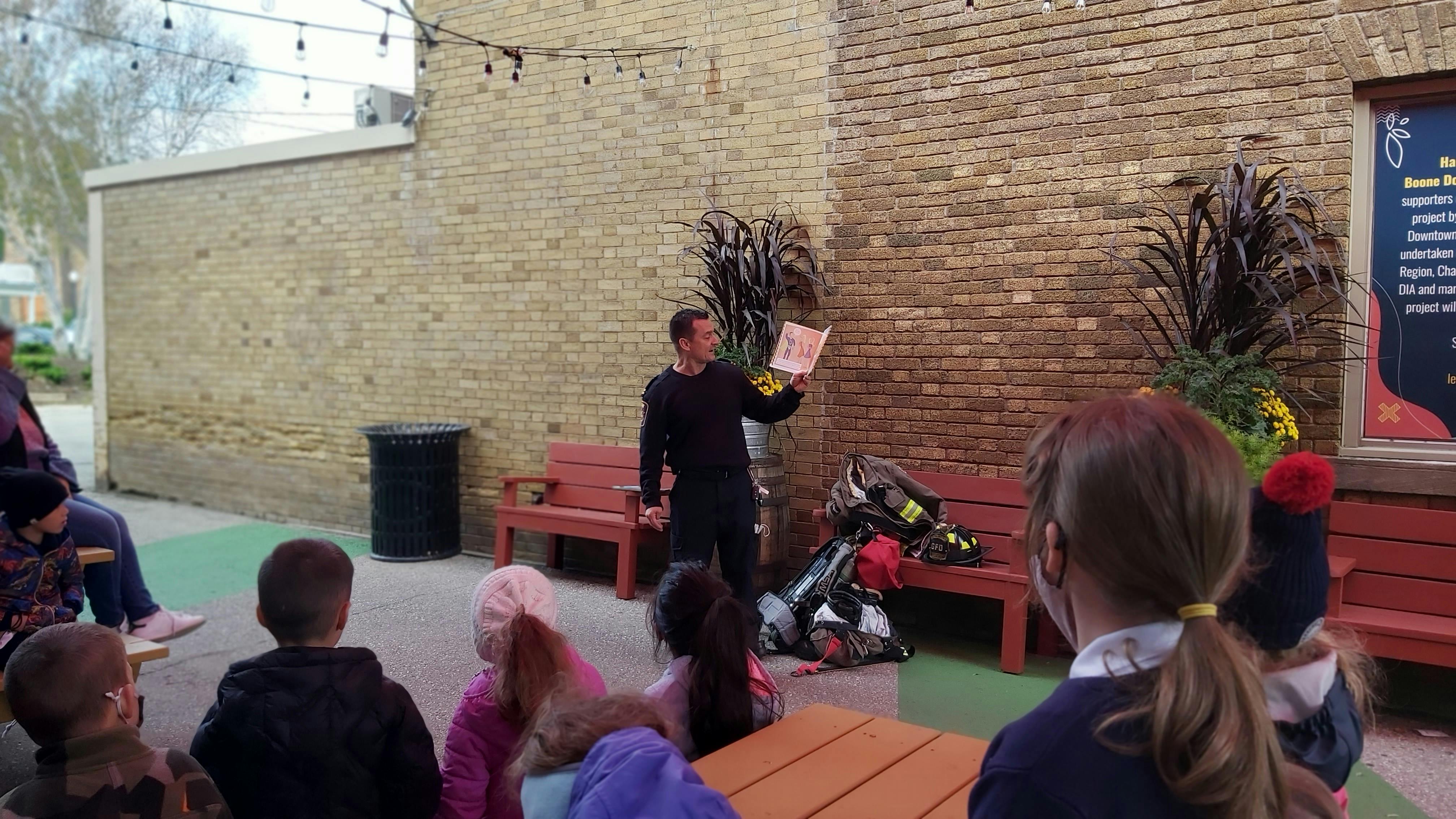 Fire Prevention Officer Reading to Students in the Grimsby Courtyard Community Space.jpg