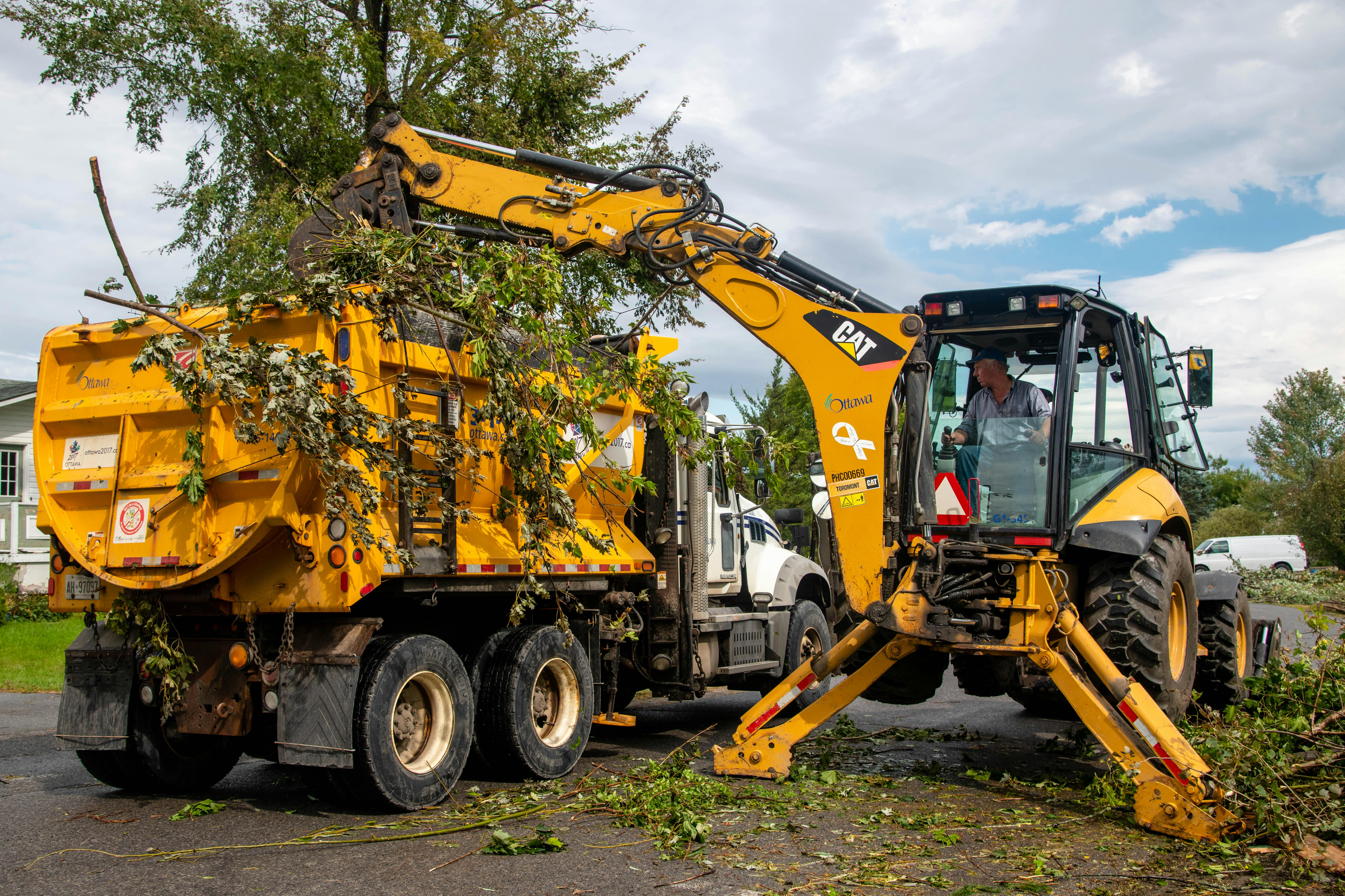 City machinery removing debris post tornado