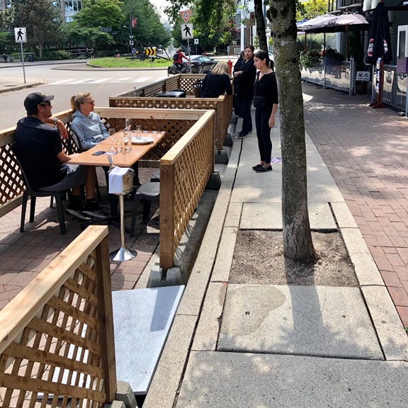 A couple sitting on a temporary patio