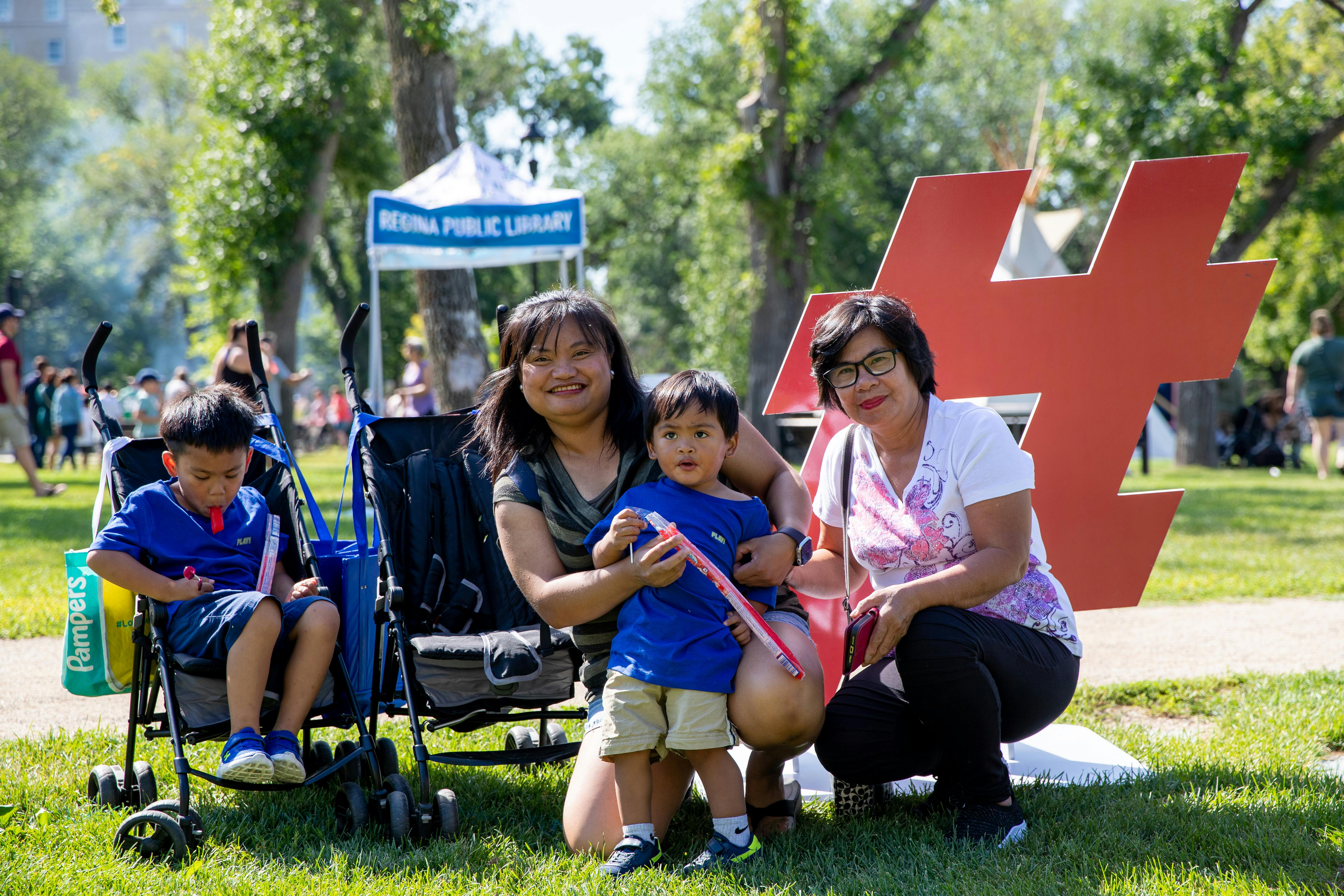 Family of two older woman and two children pose for a photo at I Love Regina Day.