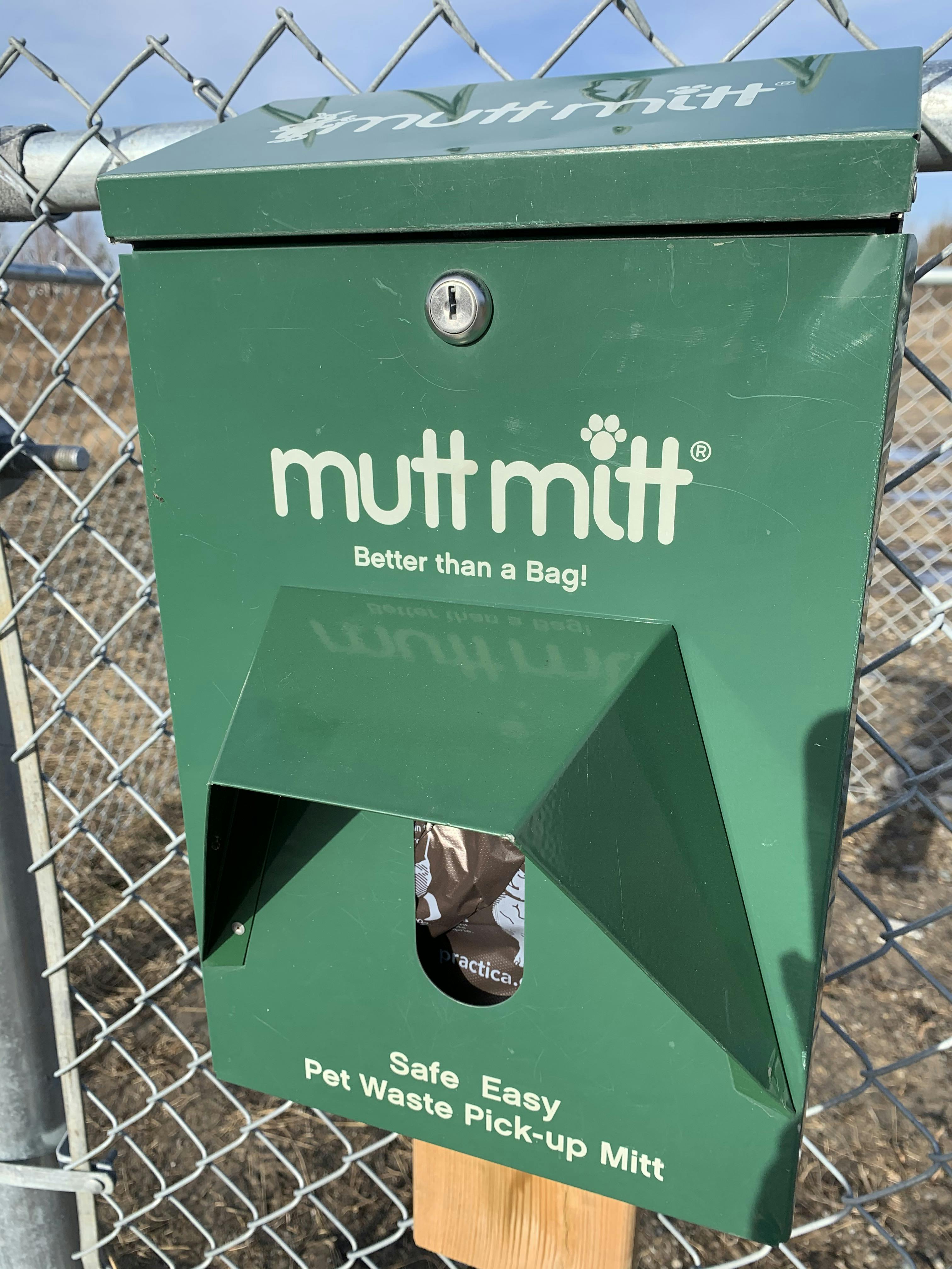 Mutt Mitt on big dog enclosure gate