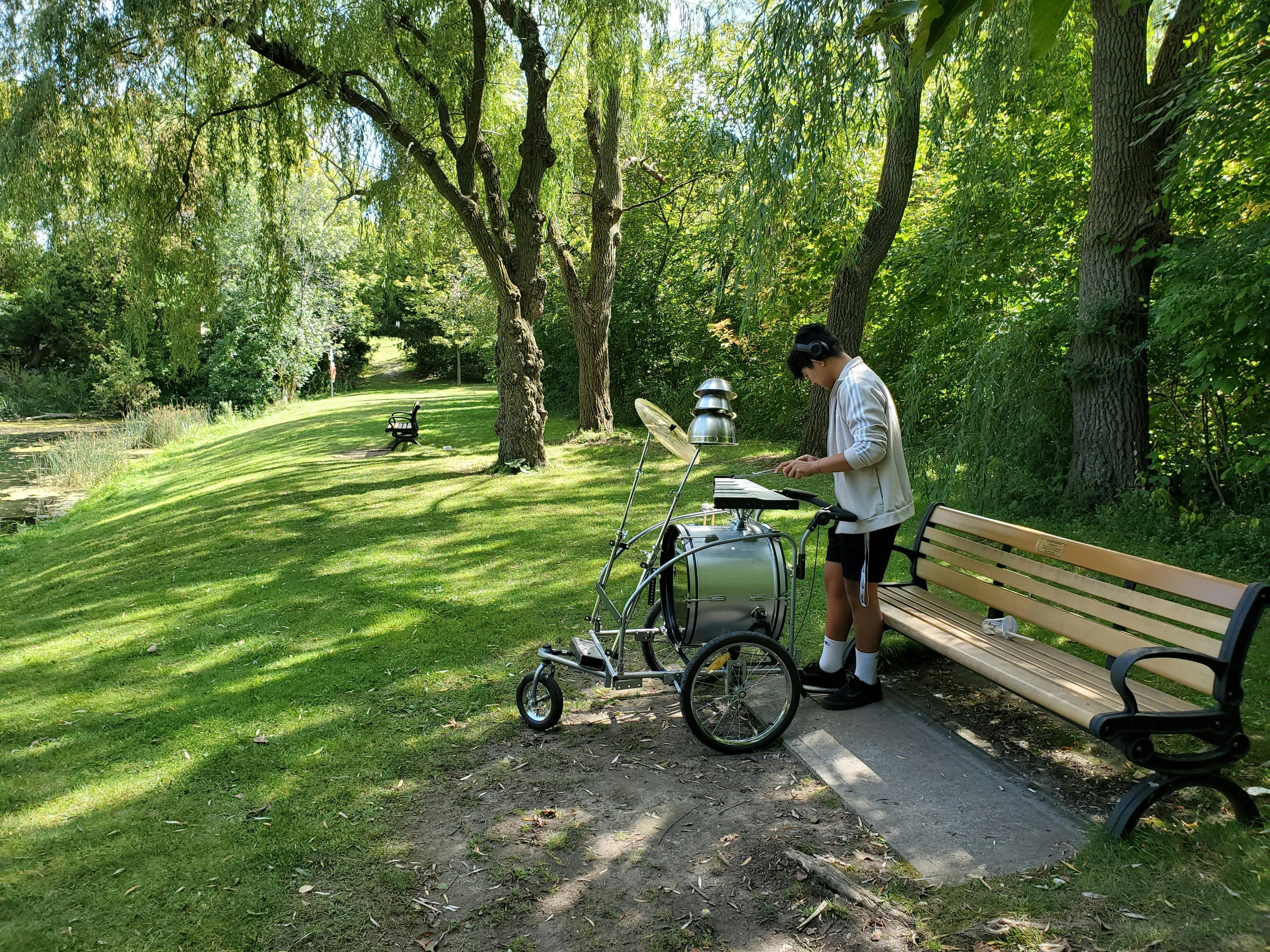 Local musician playing the music cart on the Rouge River Trail in the summer of 2023 as part of Lost and Found. Photo by Alessandra Pozzuoli.
