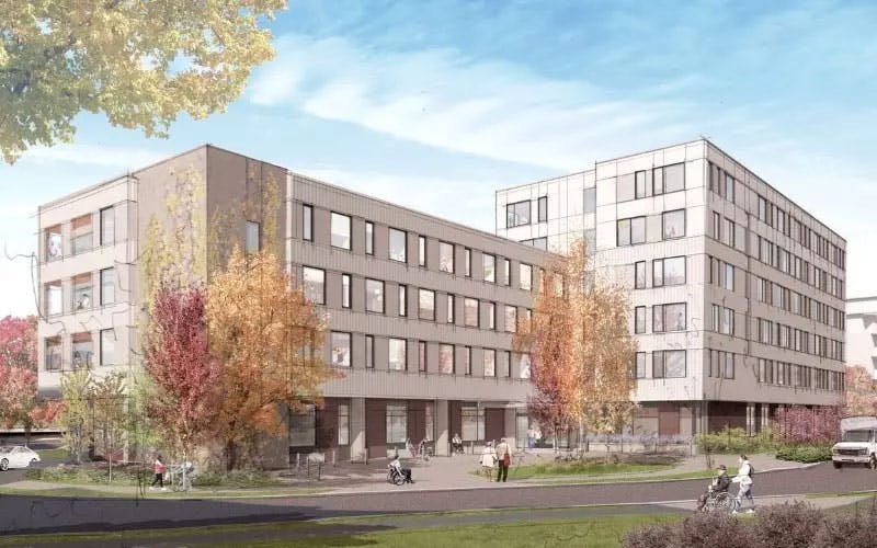 A three-story housing building connects with a four-storey building.