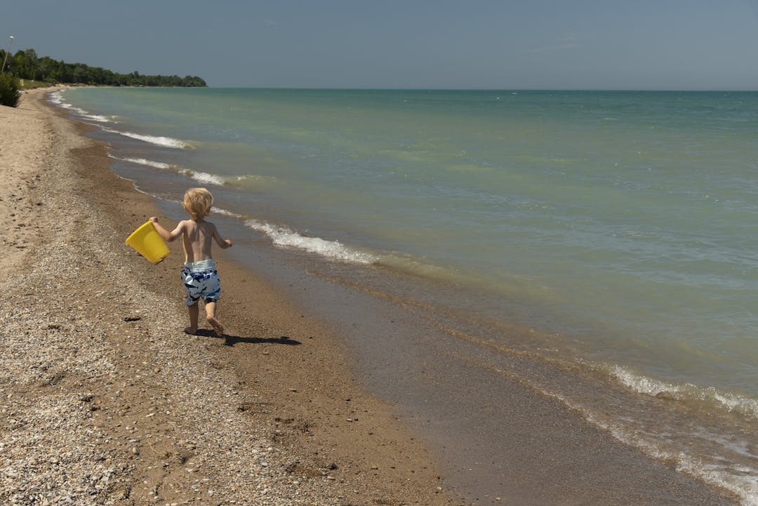 small child running on the beach
