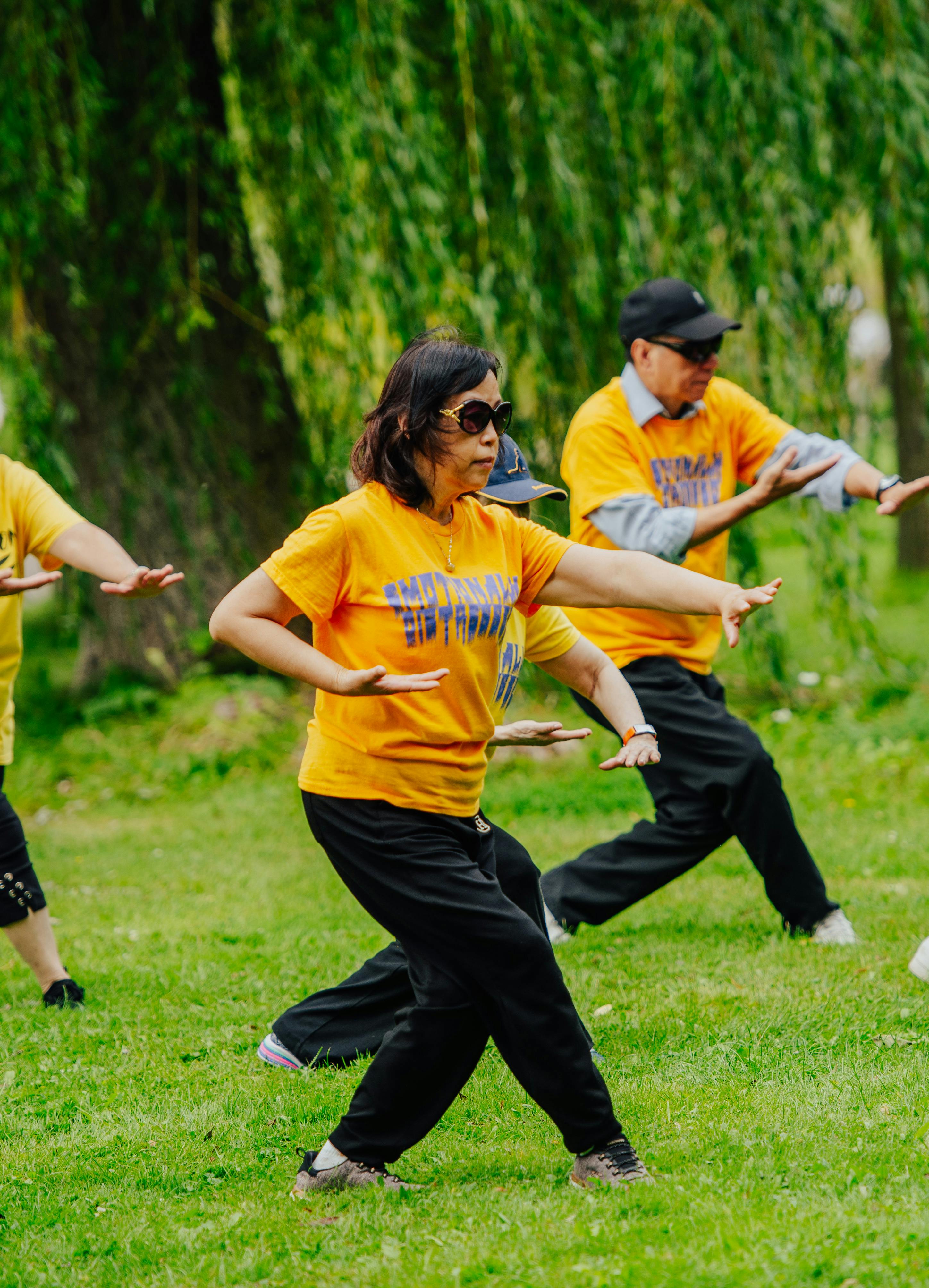 A senior group practicing Taiji in the Lost and Found T-shirts.