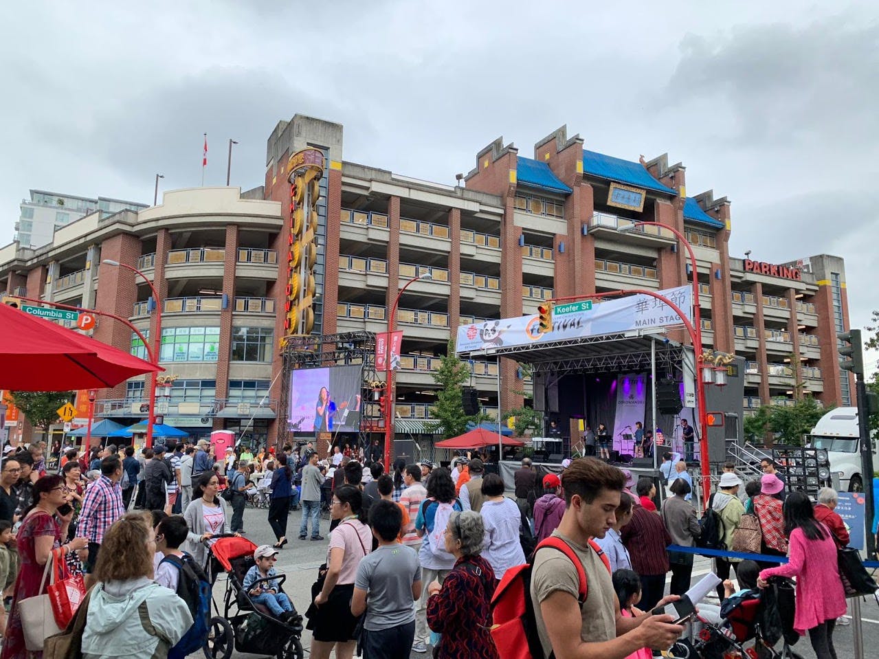 A large event with a stage for presentations is being held at Memorial Square.