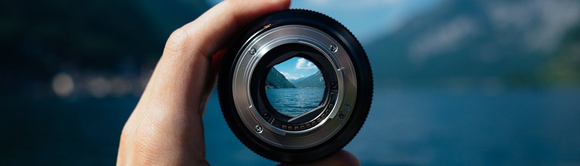 Camera lens capturing mountain scape