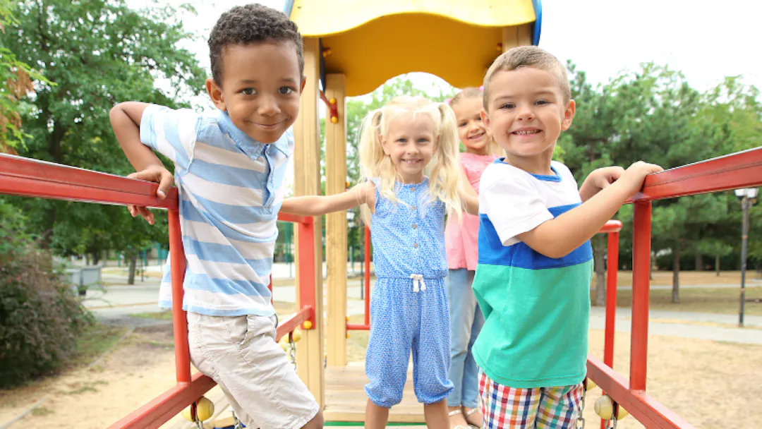 A child balances on play equipment.