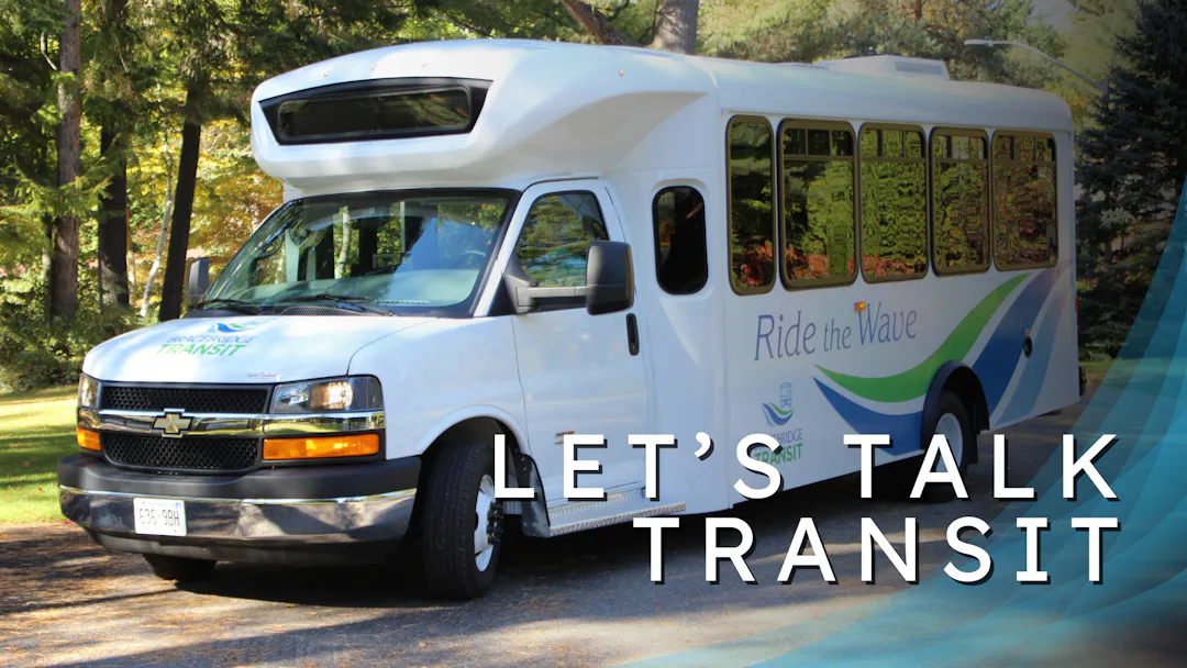 Vector image of blue transit bus stationed at bus stop.