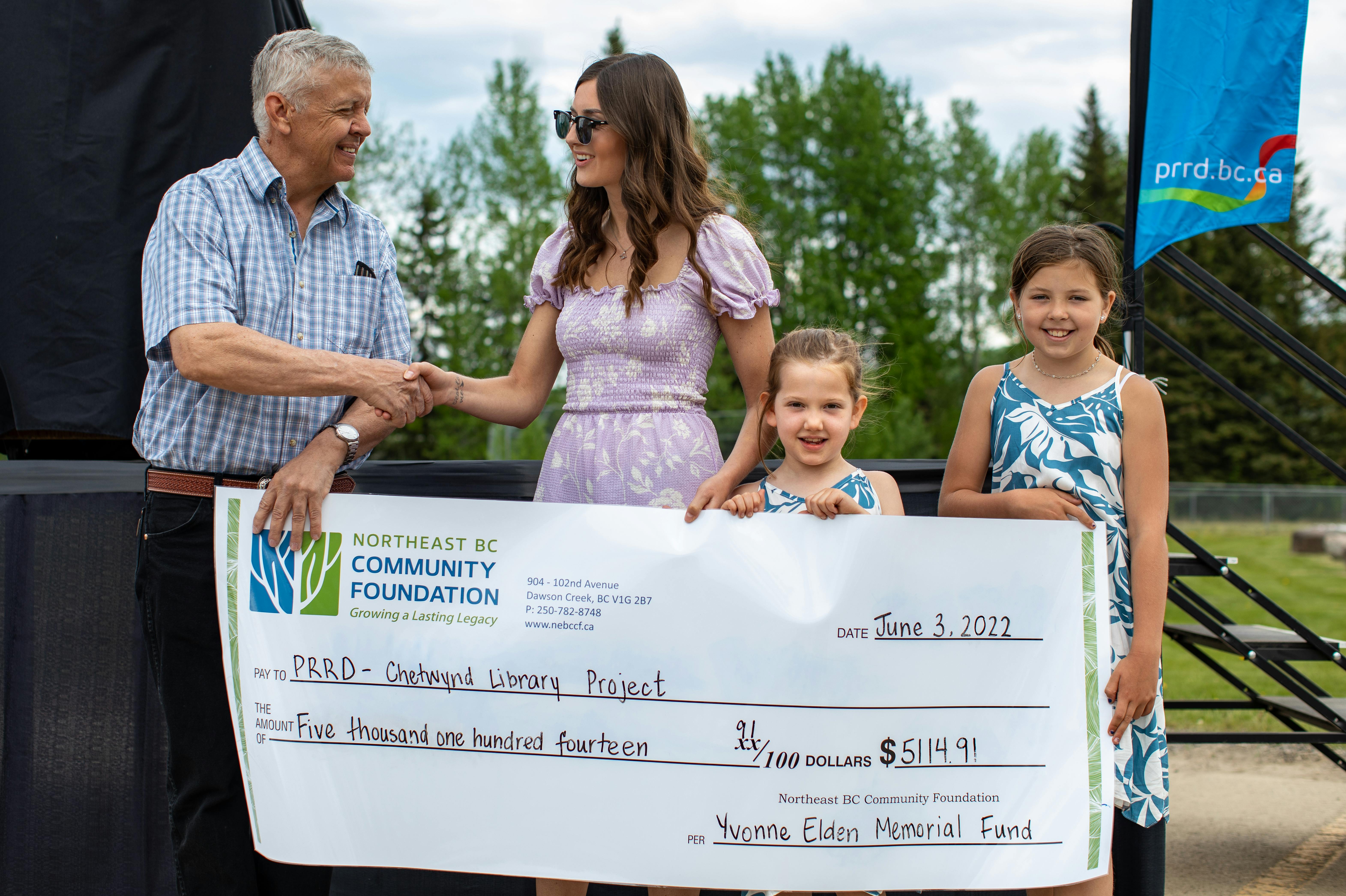 PRRD Area 'E' Director Dan Rose is presented a cheque from Kori Elden and her nieces from the Yvonne Elden Memorial Fund hosted by the Northeast BC Community Foundation. 