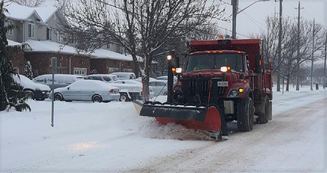 Snow plow travels through residential neighbourhood in Lincoln 