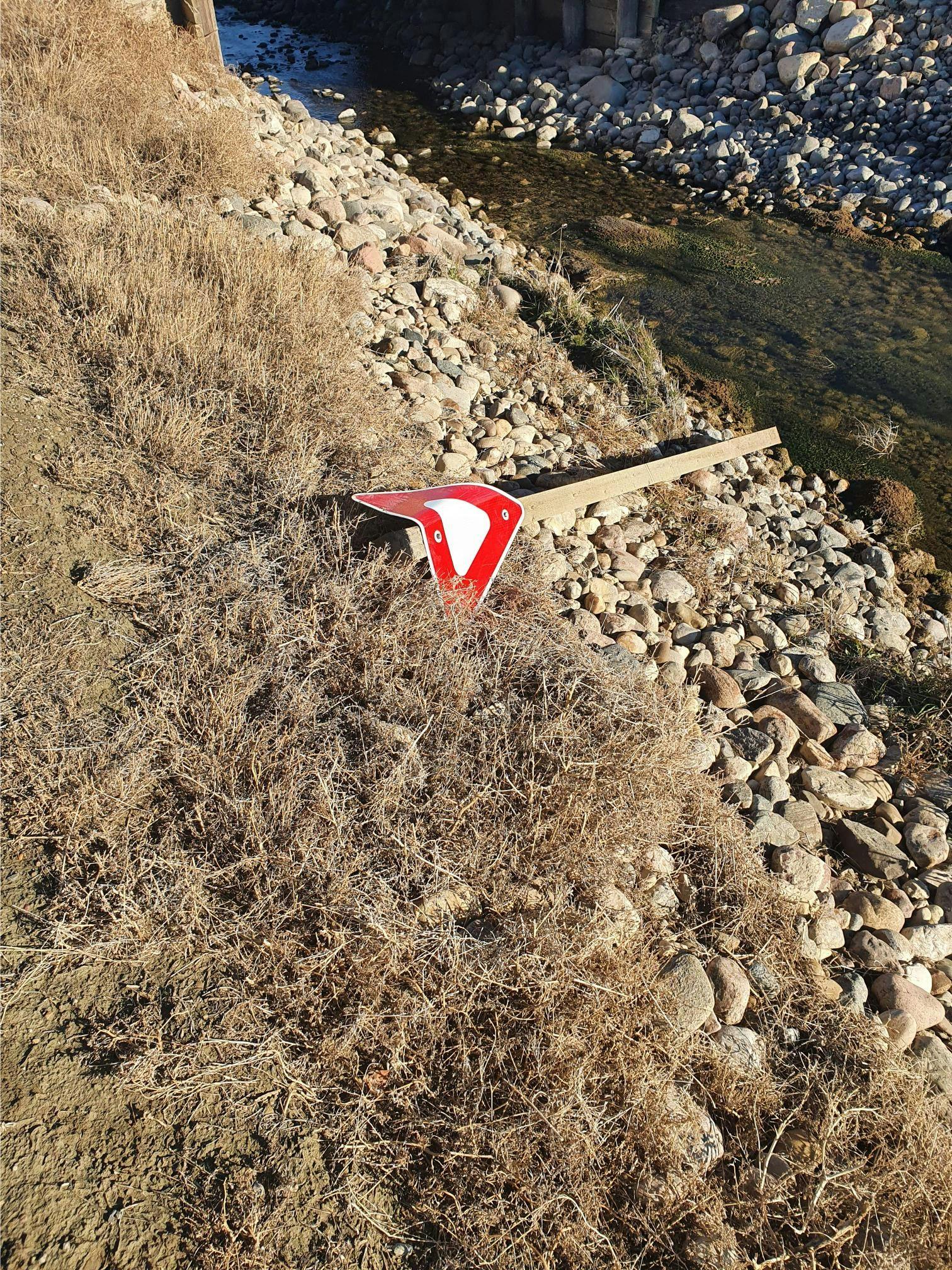Another yield sign that was removed and discarded into a canal