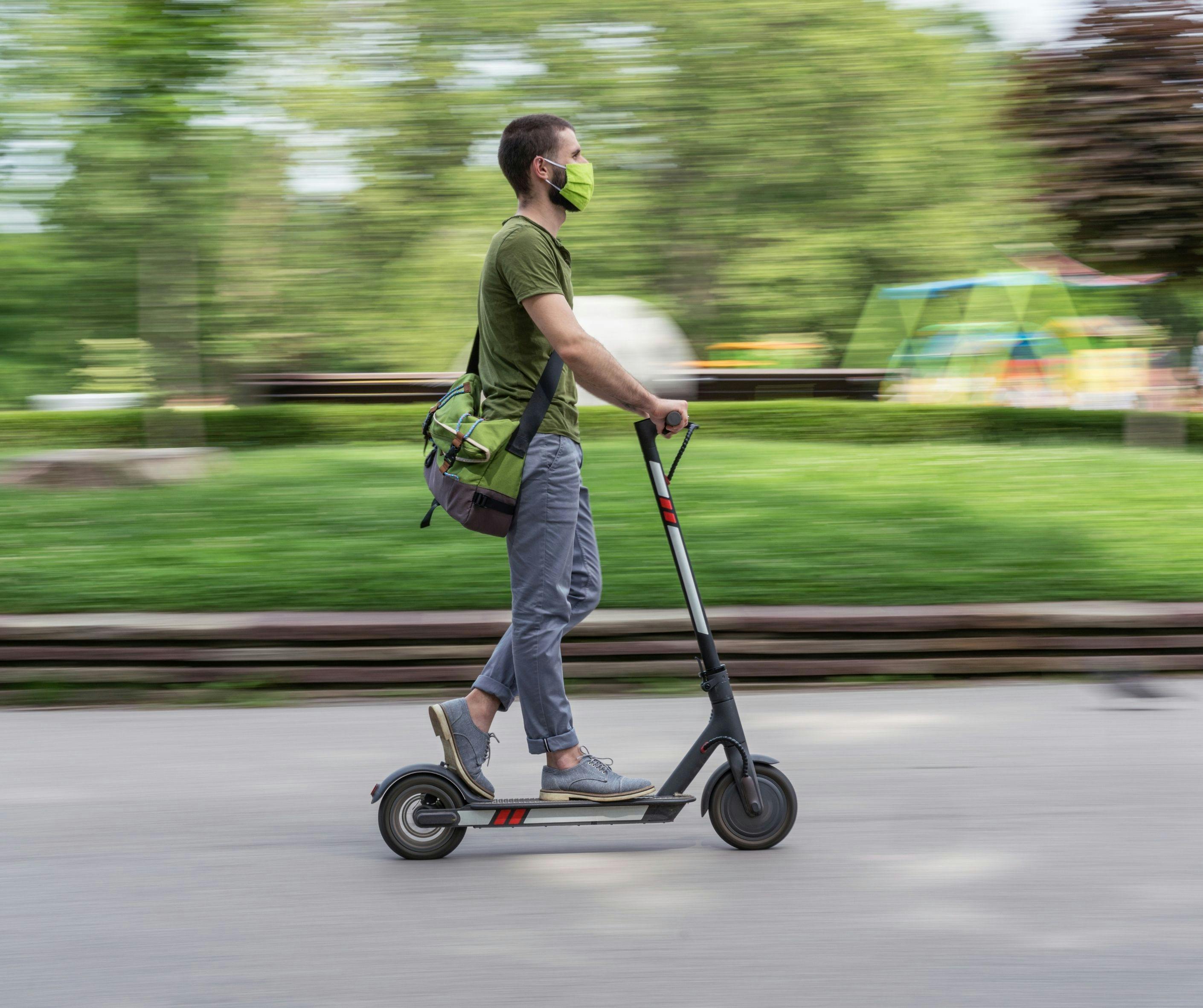 Using an e-scooter in a park setting