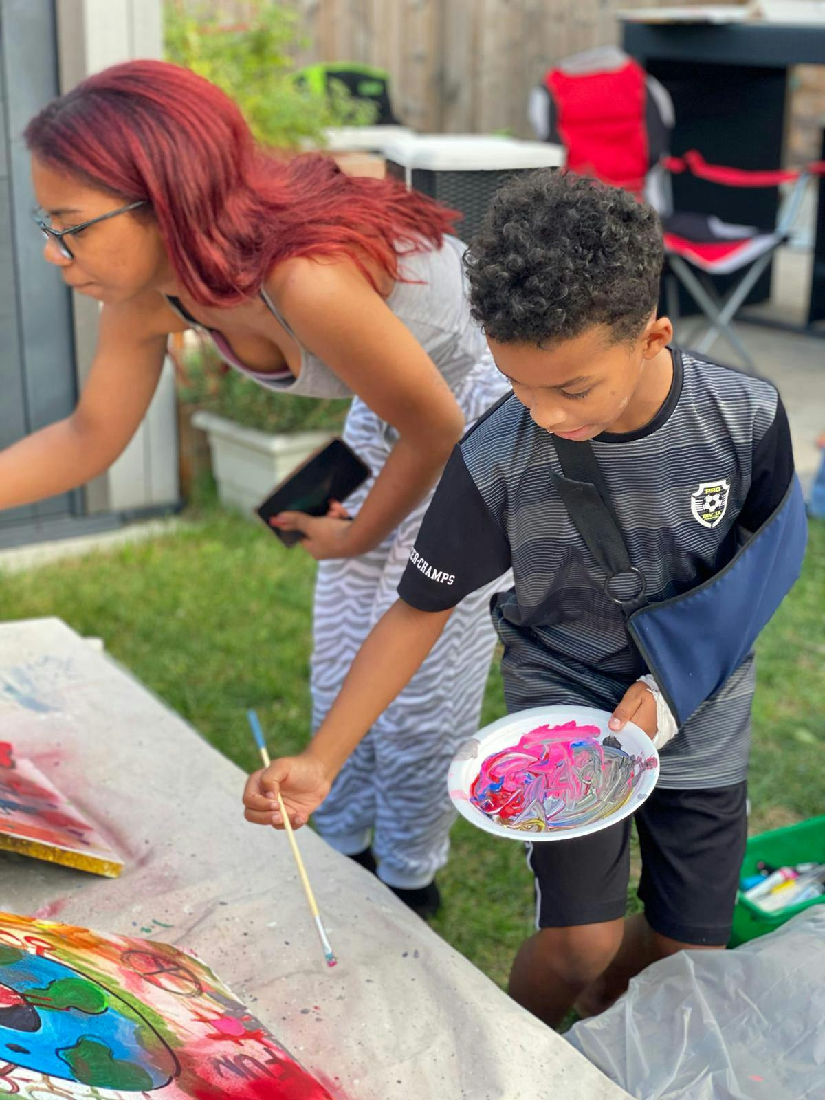 Two participants painting side by side.