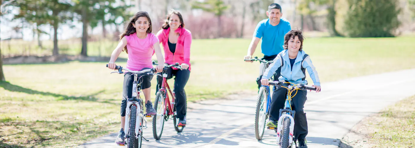 Family riding bicycles on a bike path