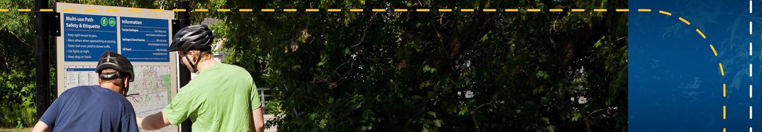 two bike riders looking at a trail map