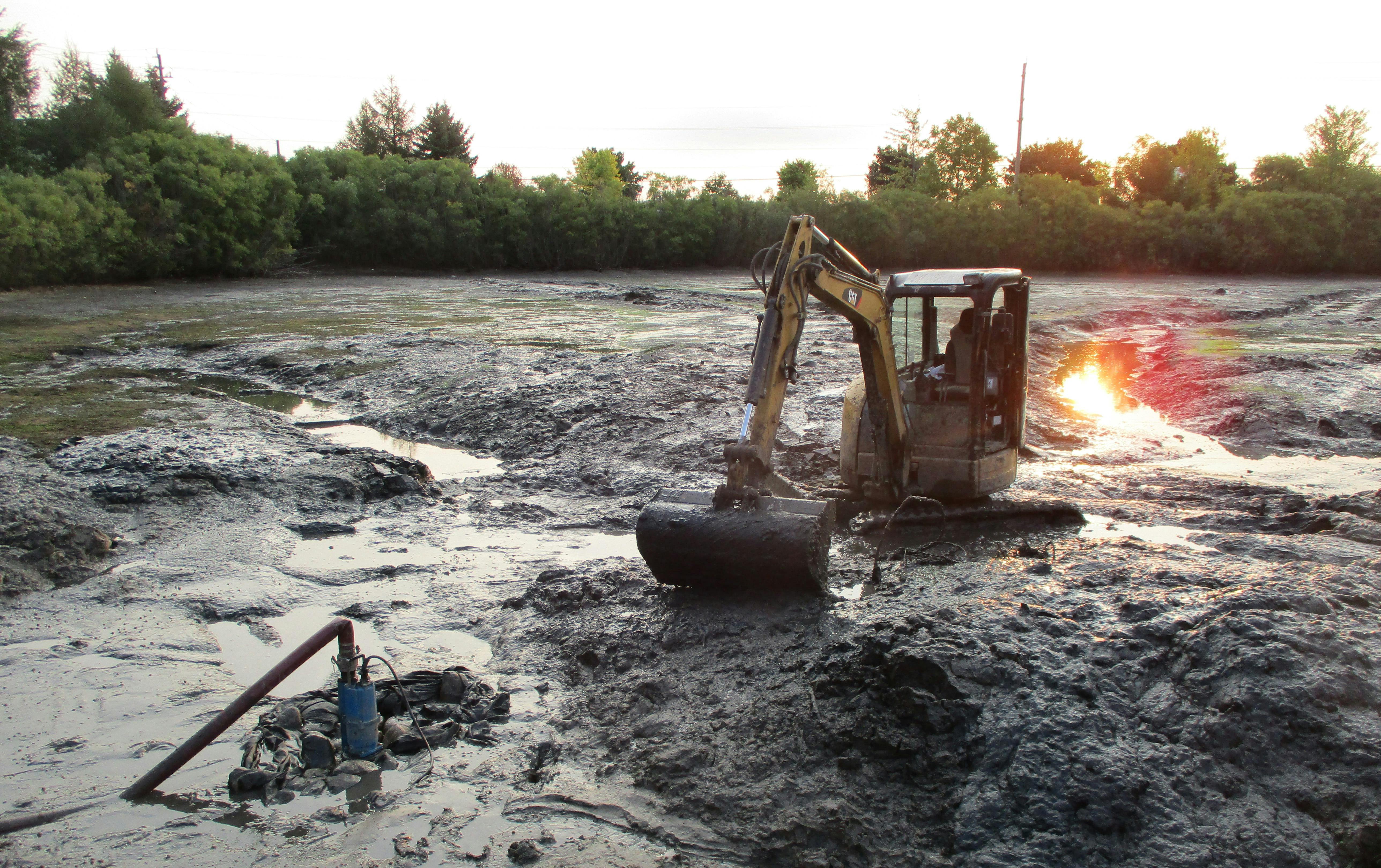Contractor removing sediment from a City stormwater management facility