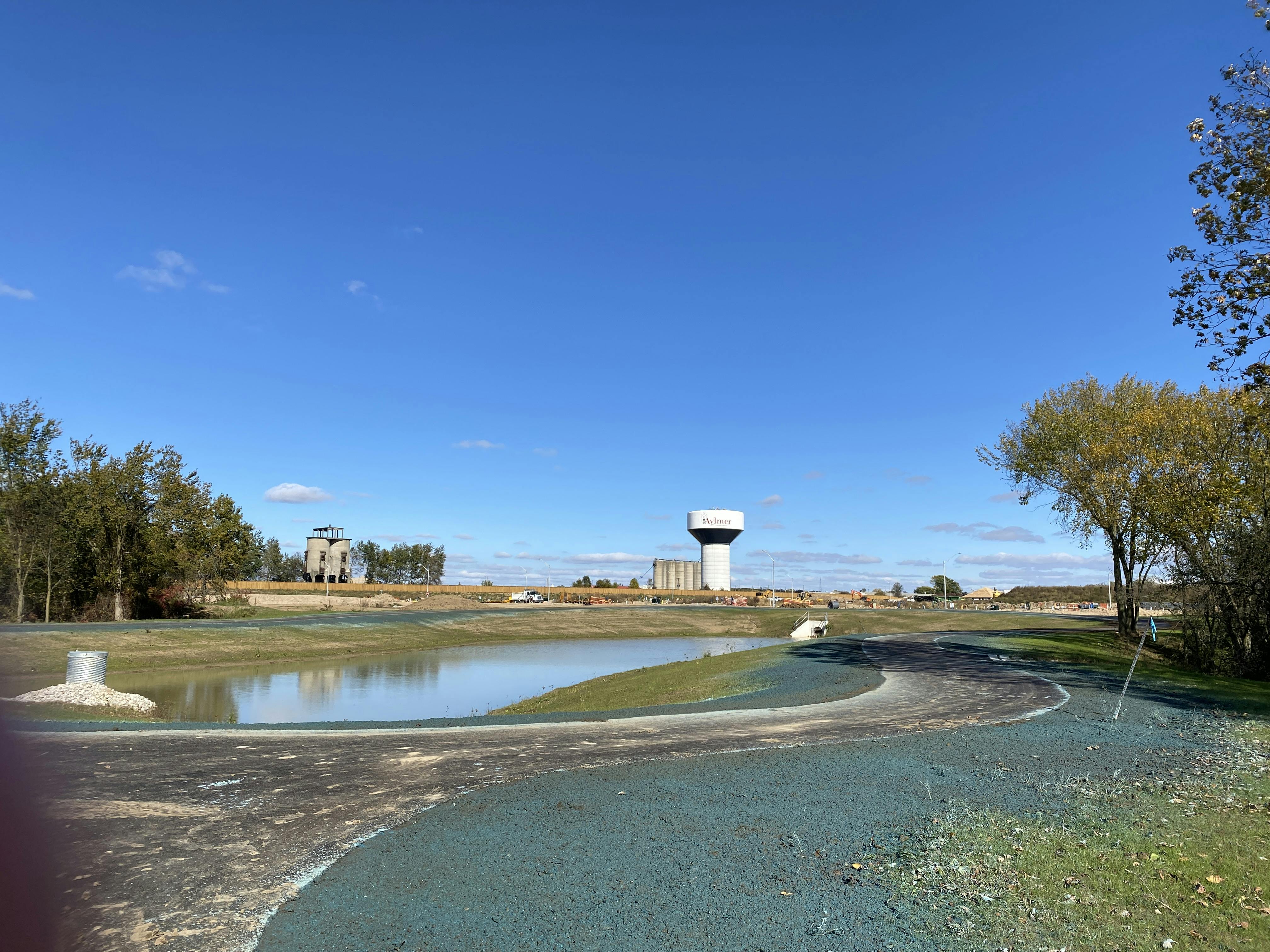 Paved trail with water tower in the background