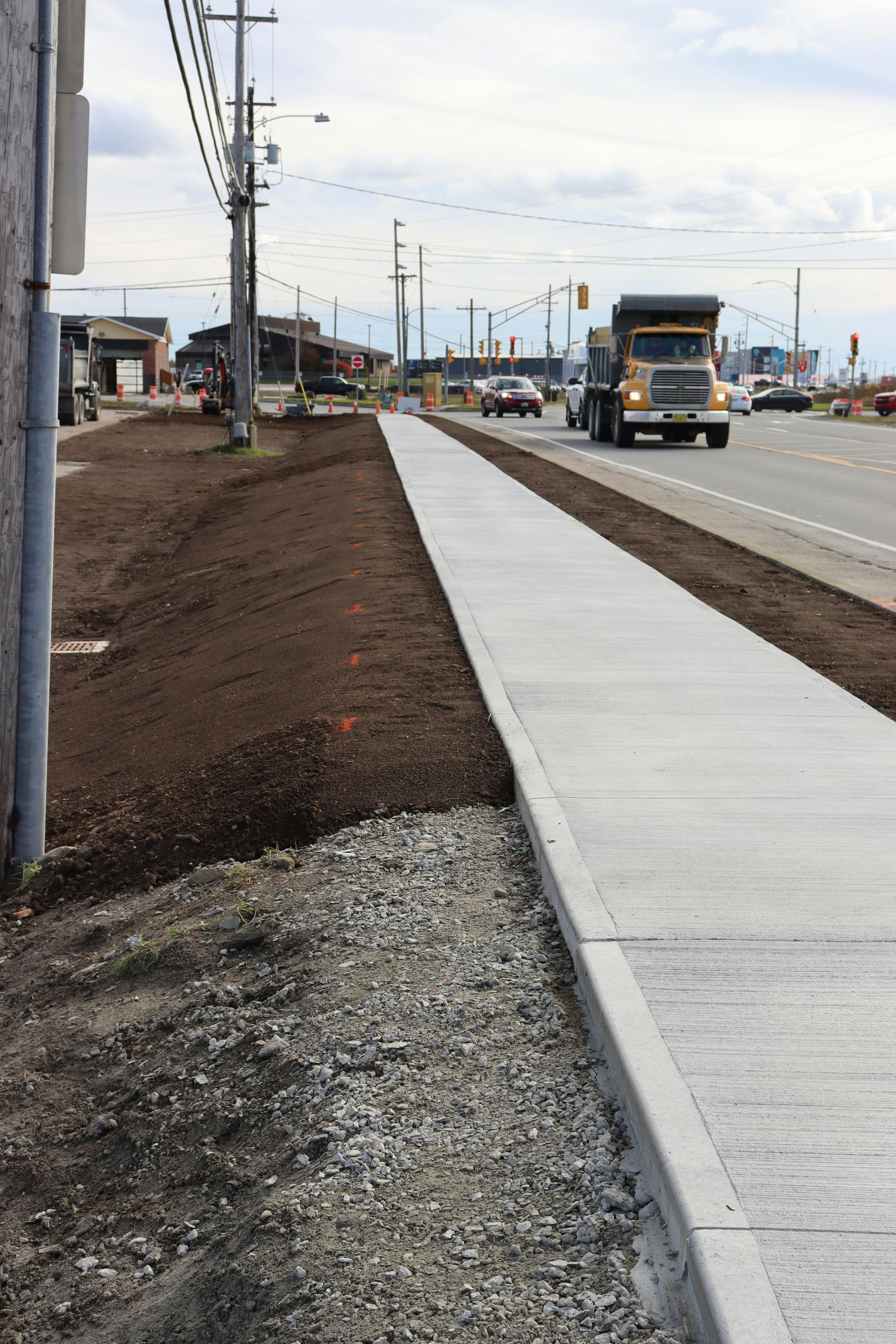 Landscaping work as the sidewalk project on Starrs Road is completed.