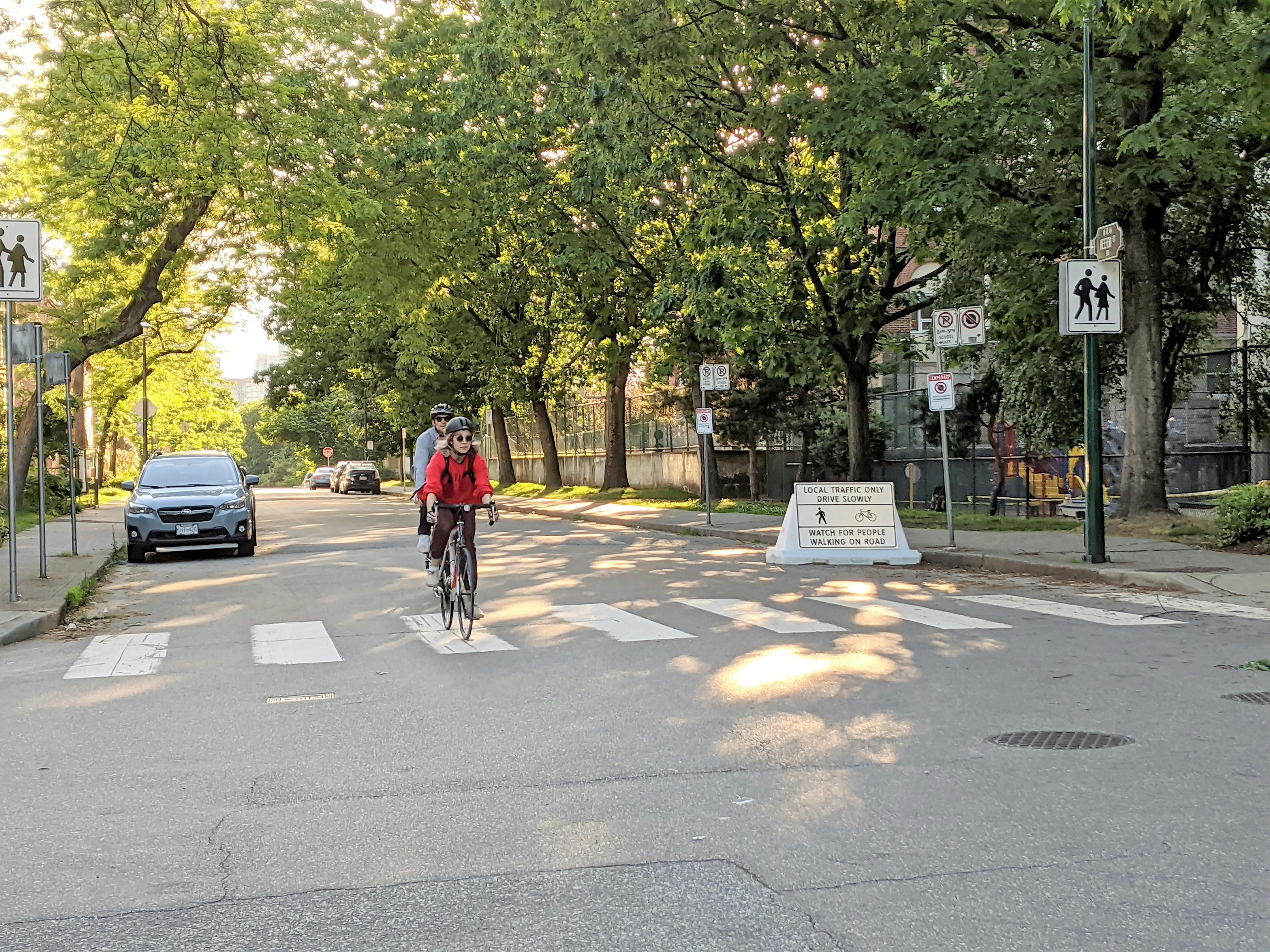 Two people cycling along Slow Streets - Keefer Street and Princess Ave 