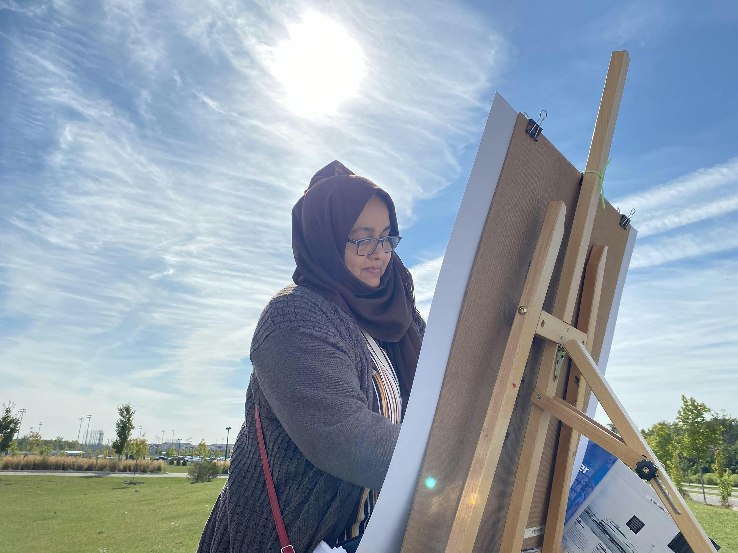 Nargis working at an easel. 