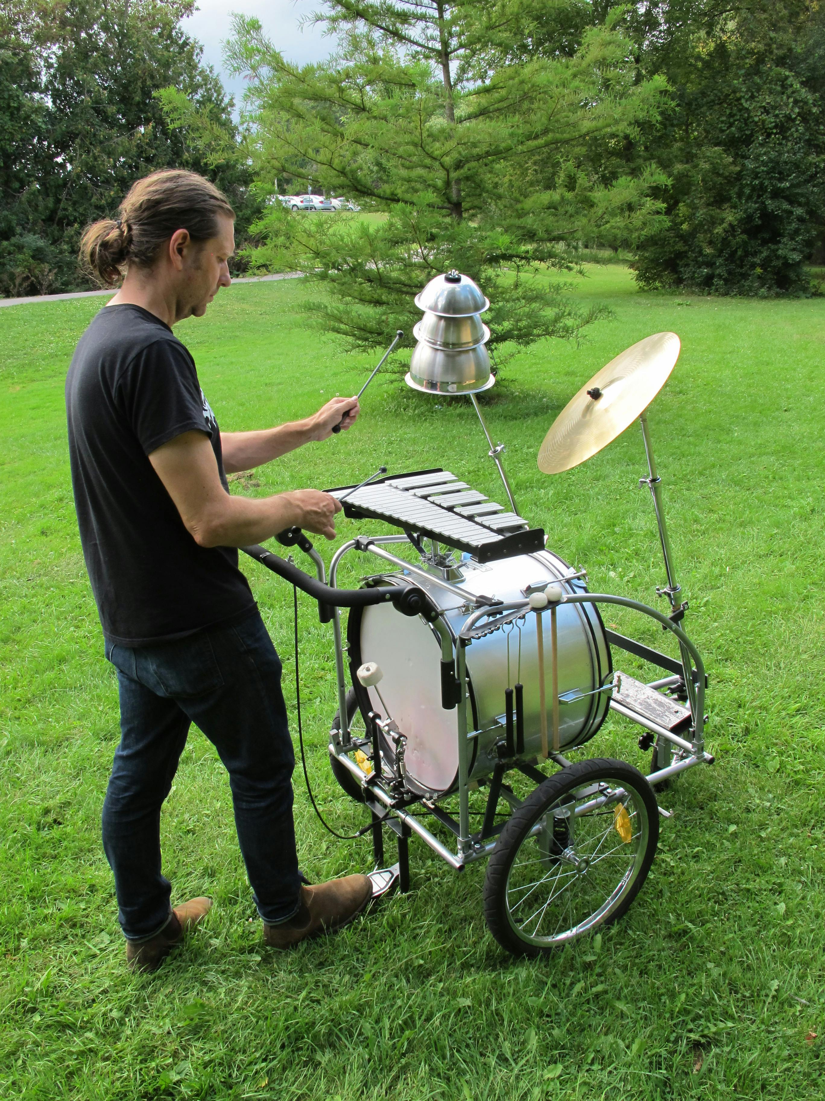 Artist Kevin Schmidt playing the Lost and Found music cart.