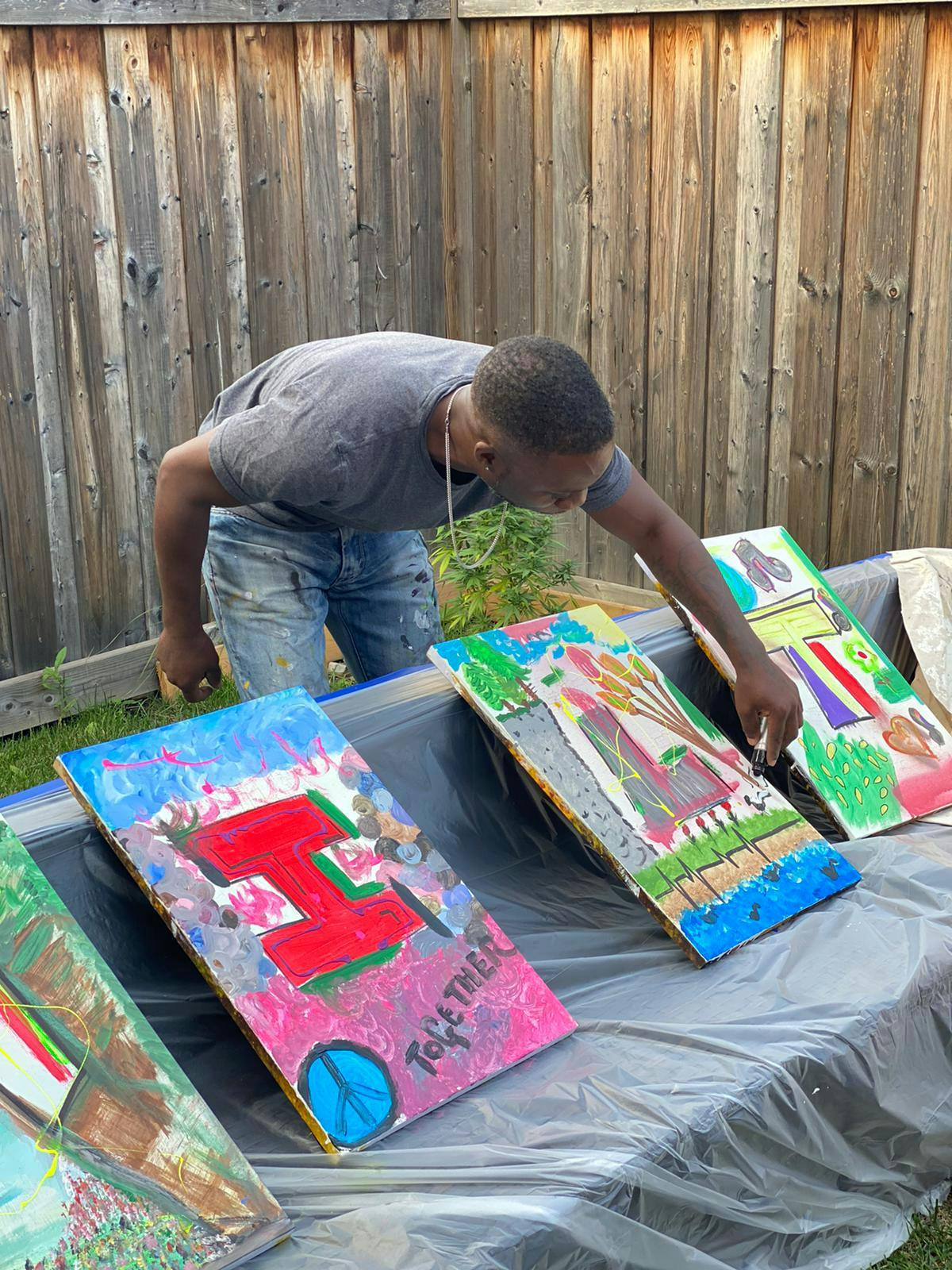 Artist-facilitator Omar drawing on canvas.