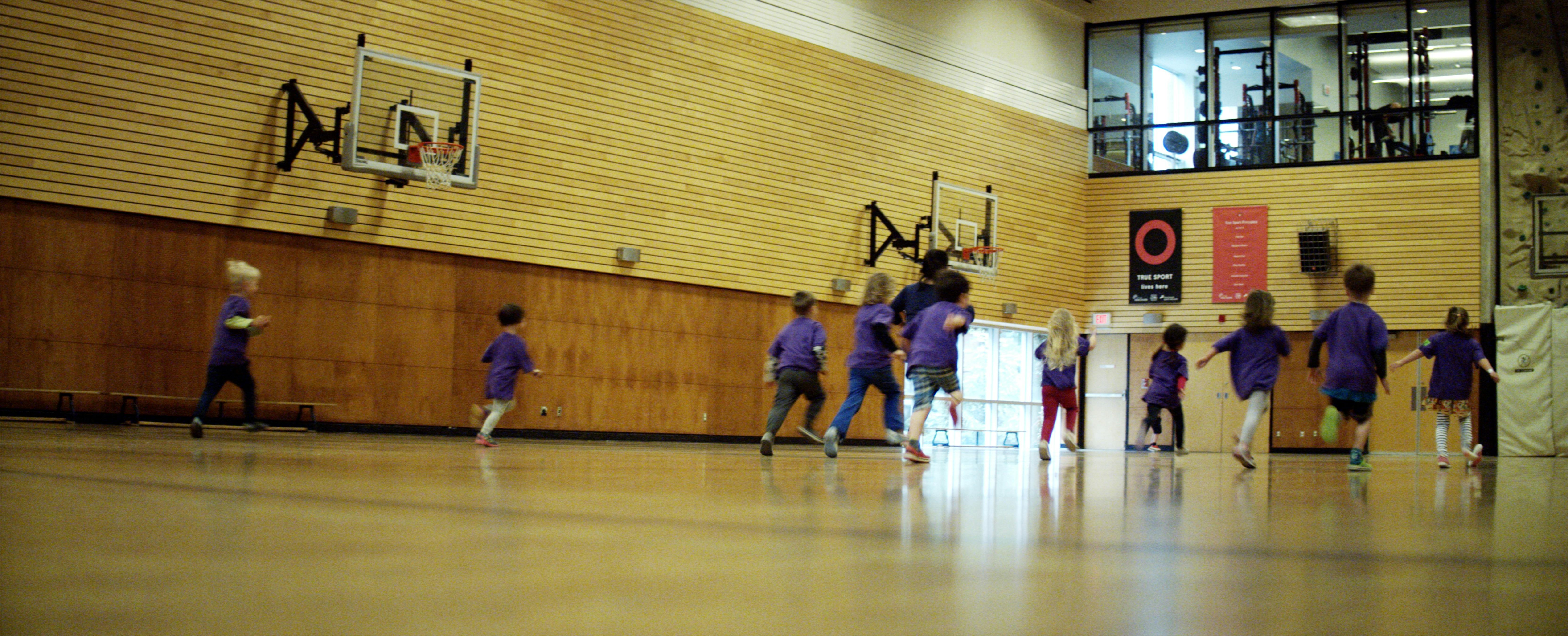 Children running in a gymnasium