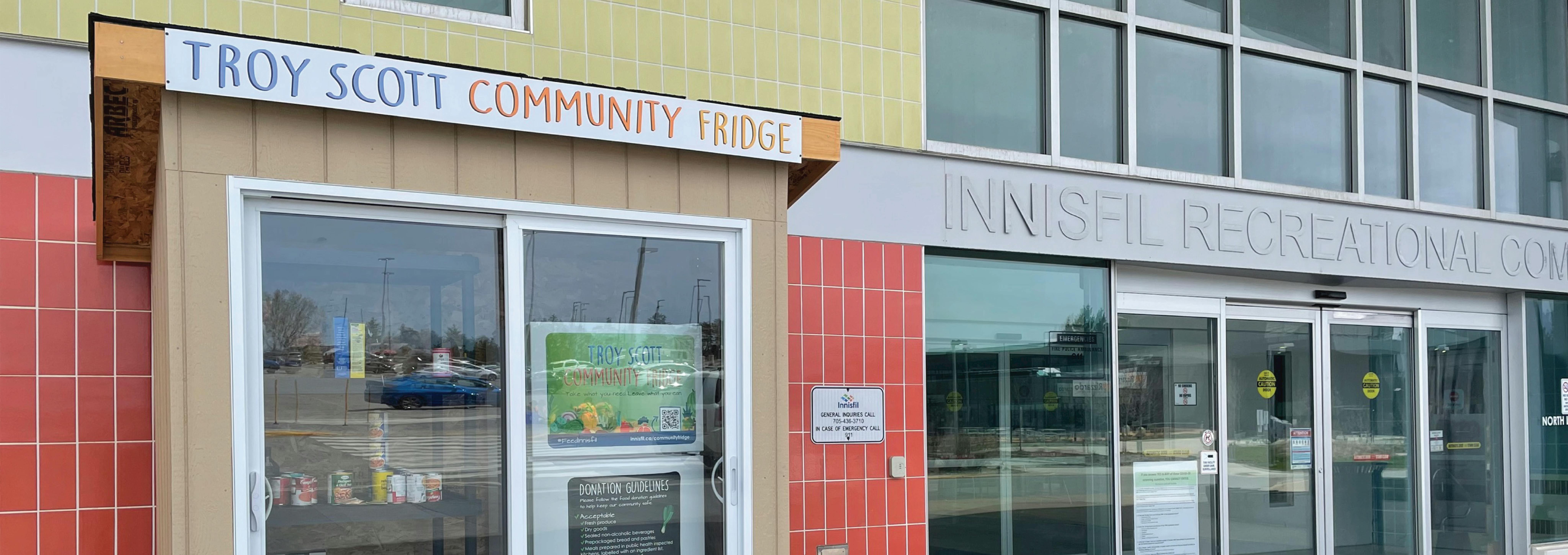 Community fridge outdoors with the name Troy Scott Community Fridge