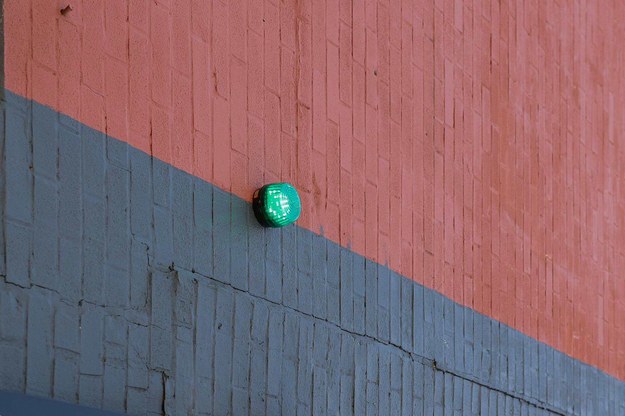 Project Greenlight camera installed on side of red and black building
