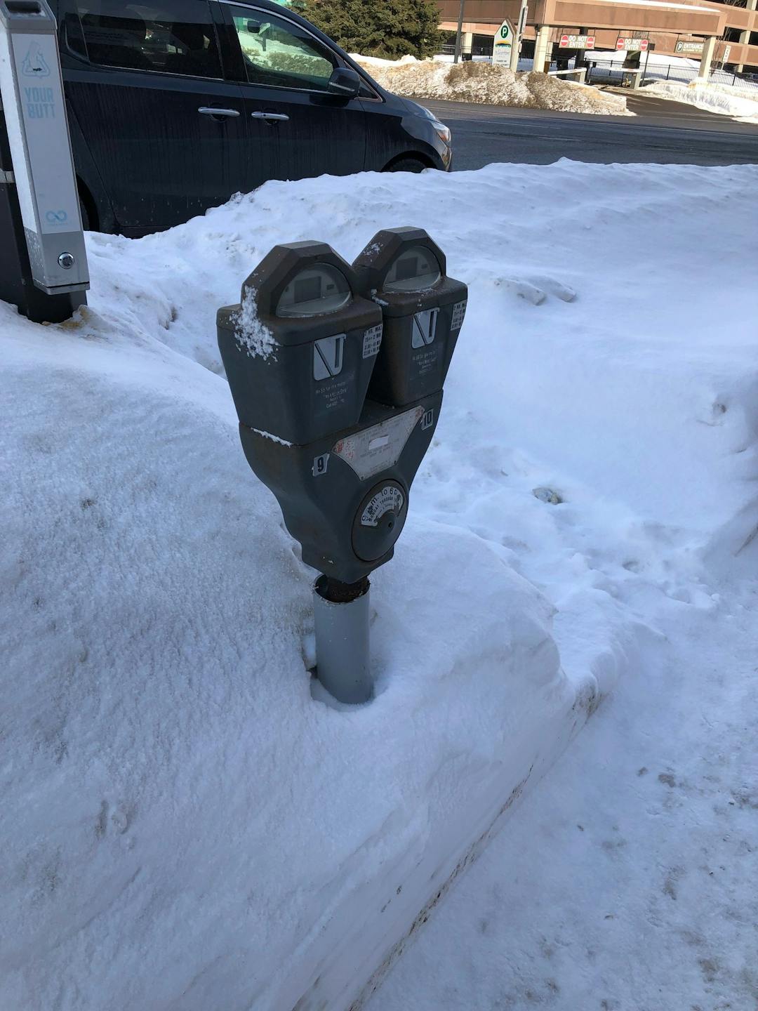 A parking meter in the winter