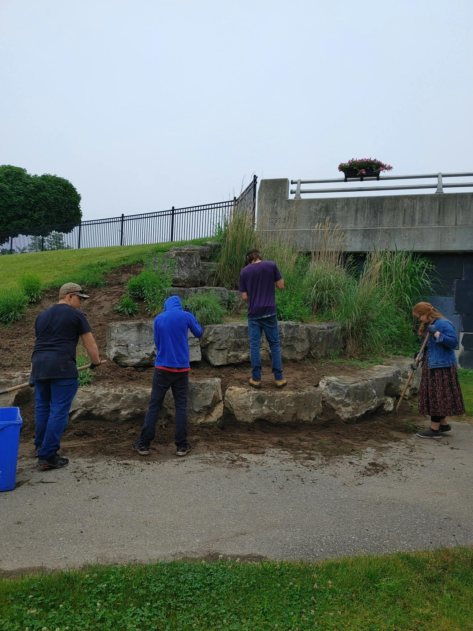Volunteers digging out the gardens at Balmoral Park