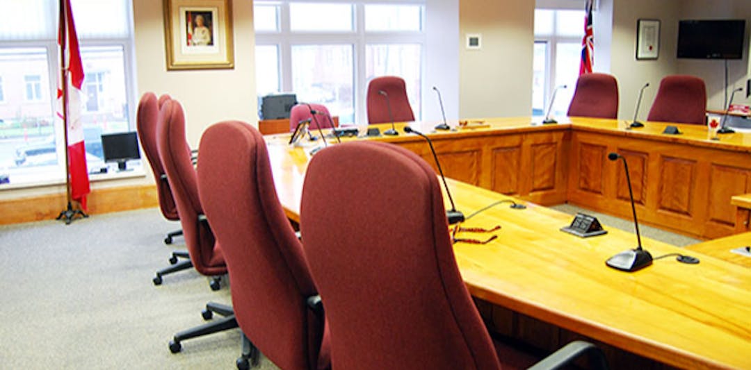 view of Council Chambers room - table, chairs, Canada Flag and Queen photo