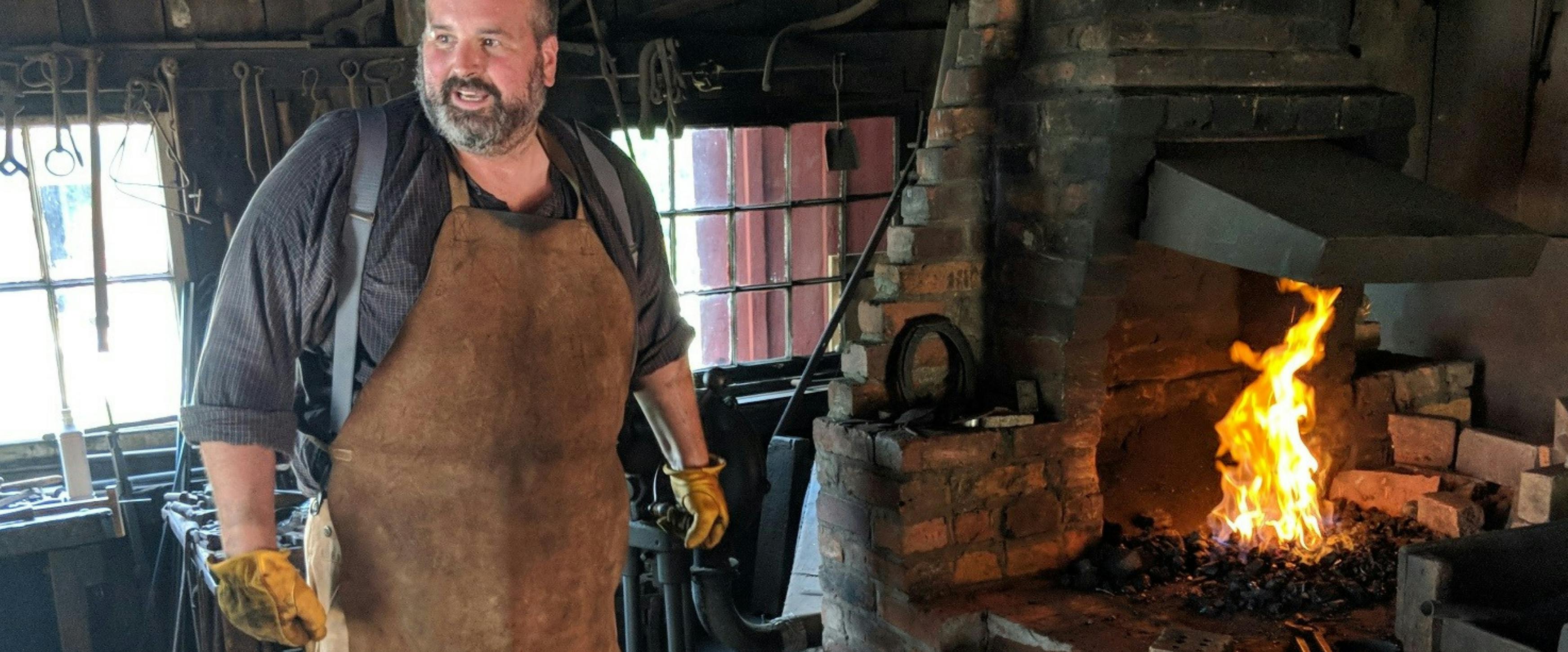 Volunteer Blacksmith working at the forge