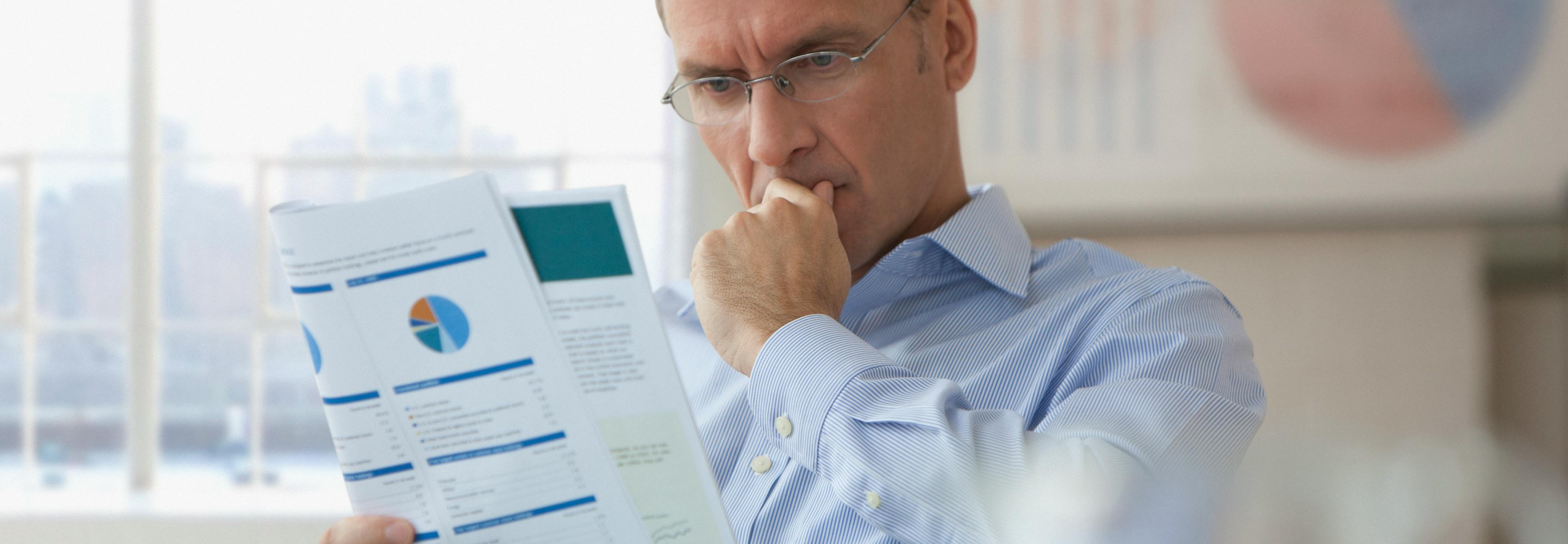 Man reading report before providing feedback on consultation