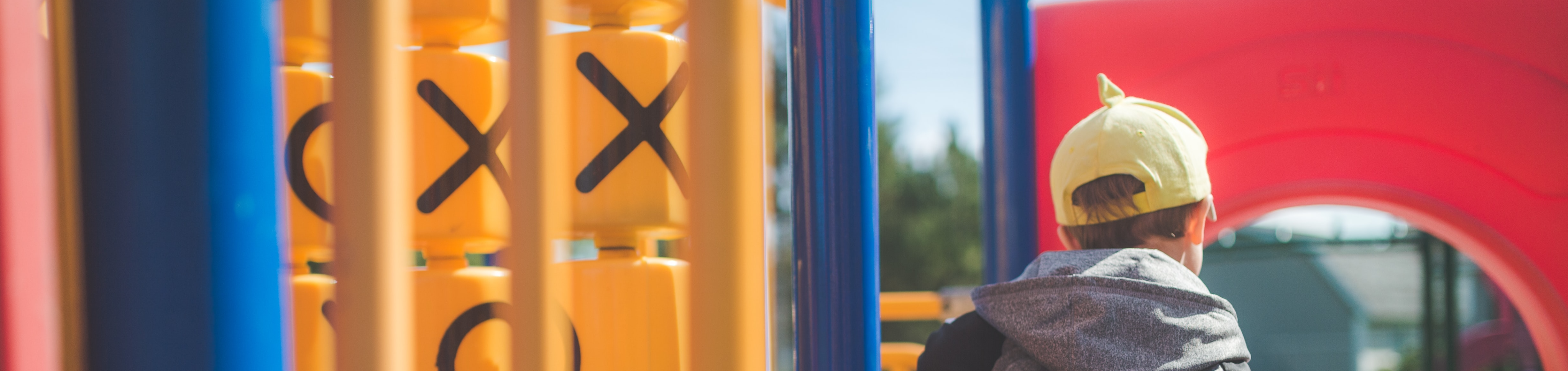 A child sitting on a playground structure.
