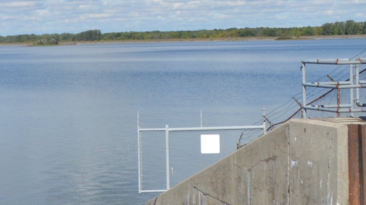 staff on top of concrete wall next to Lake St. Lawrence