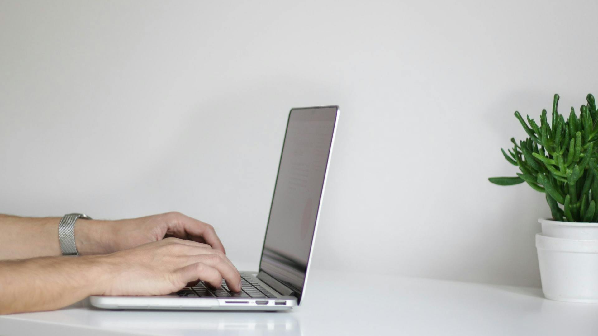 Image of fingers on a laptop keyboard