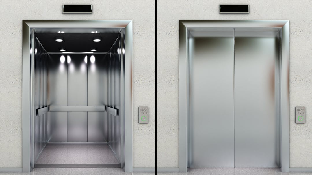 Two elevators, one with doors open, one with doors closed
