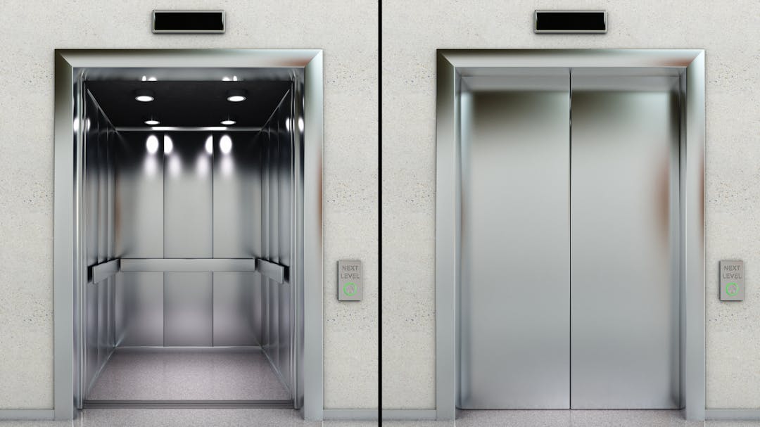 Two elevators, one with doors open, one with doors closed