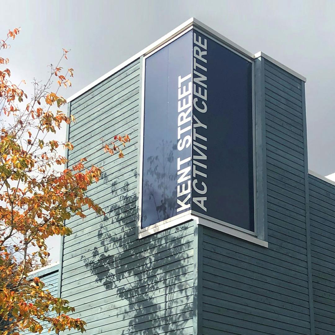 blue building with orange leaves and blue sky