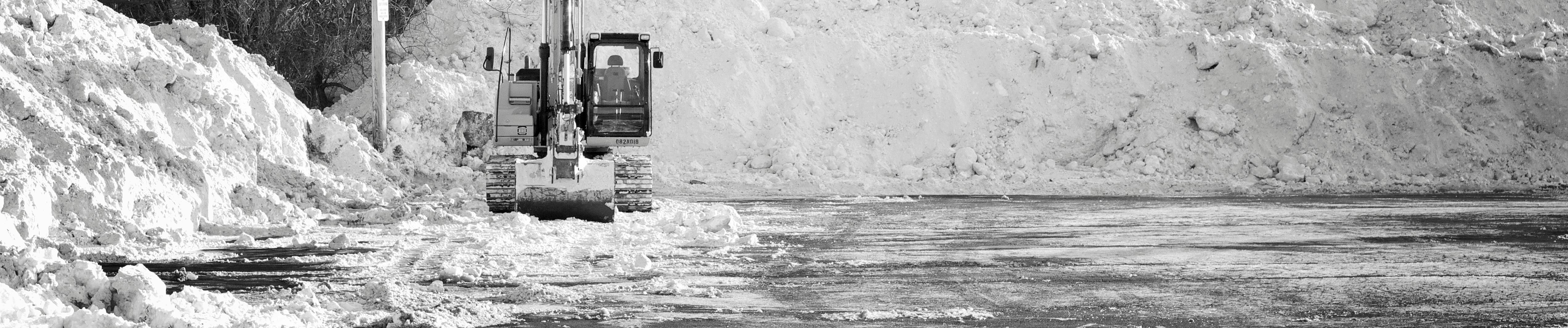 Excavator clearing snow