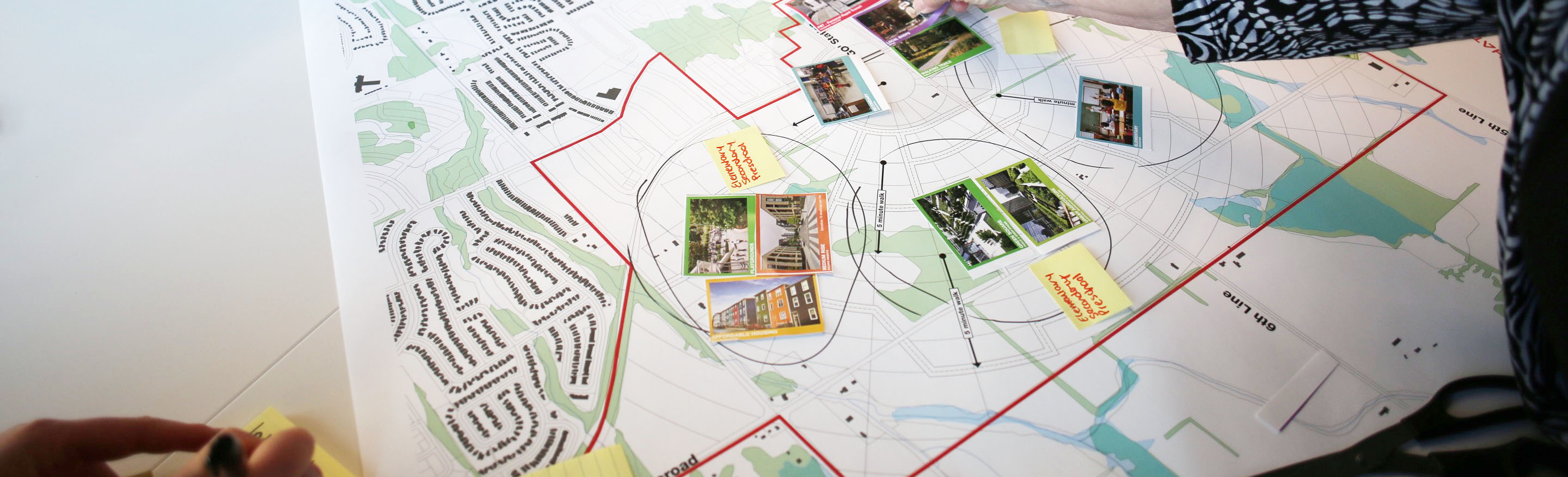 Aerial view of futuristic city amongst lake and farmland