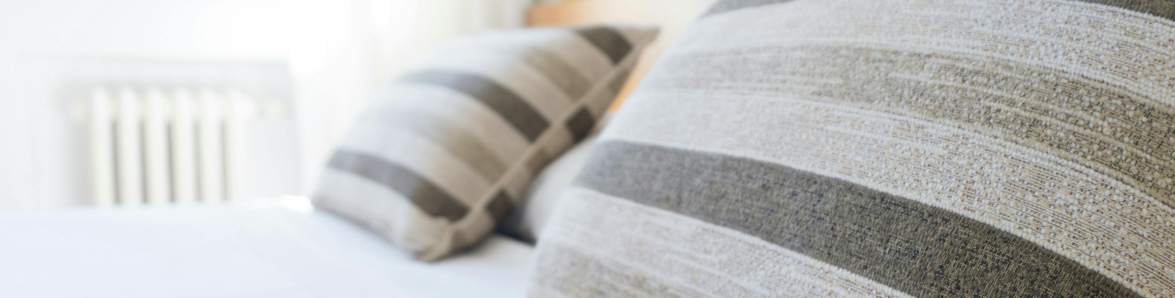 A bed with decorative pillows