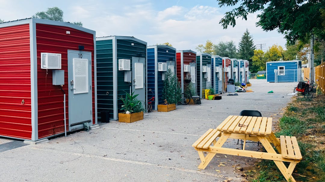 row of modular housing units with a picnic table in the front