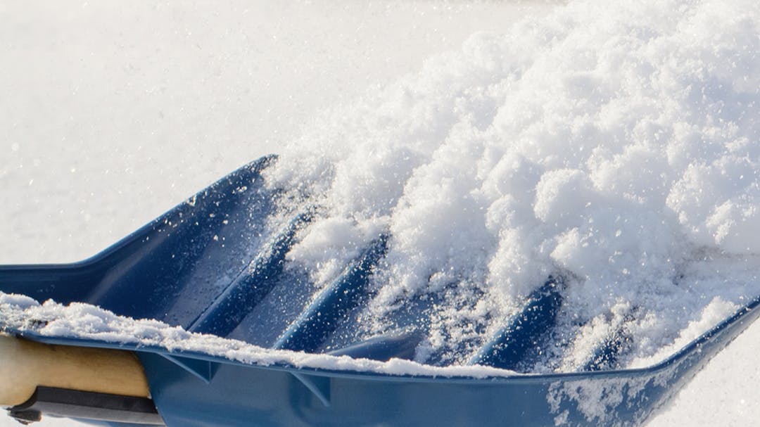 Blue Shovel with snow on it
