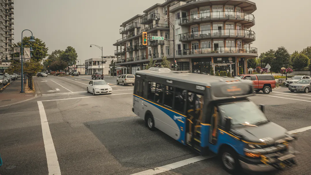 A community shuttle bus driving through an intersection