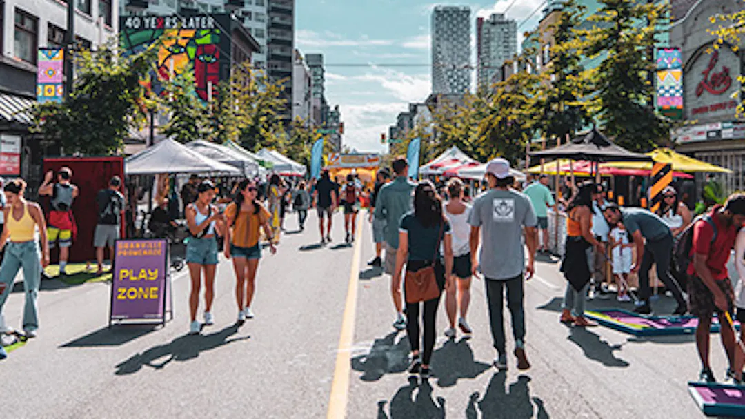 People walking on Granville Street during a festival 