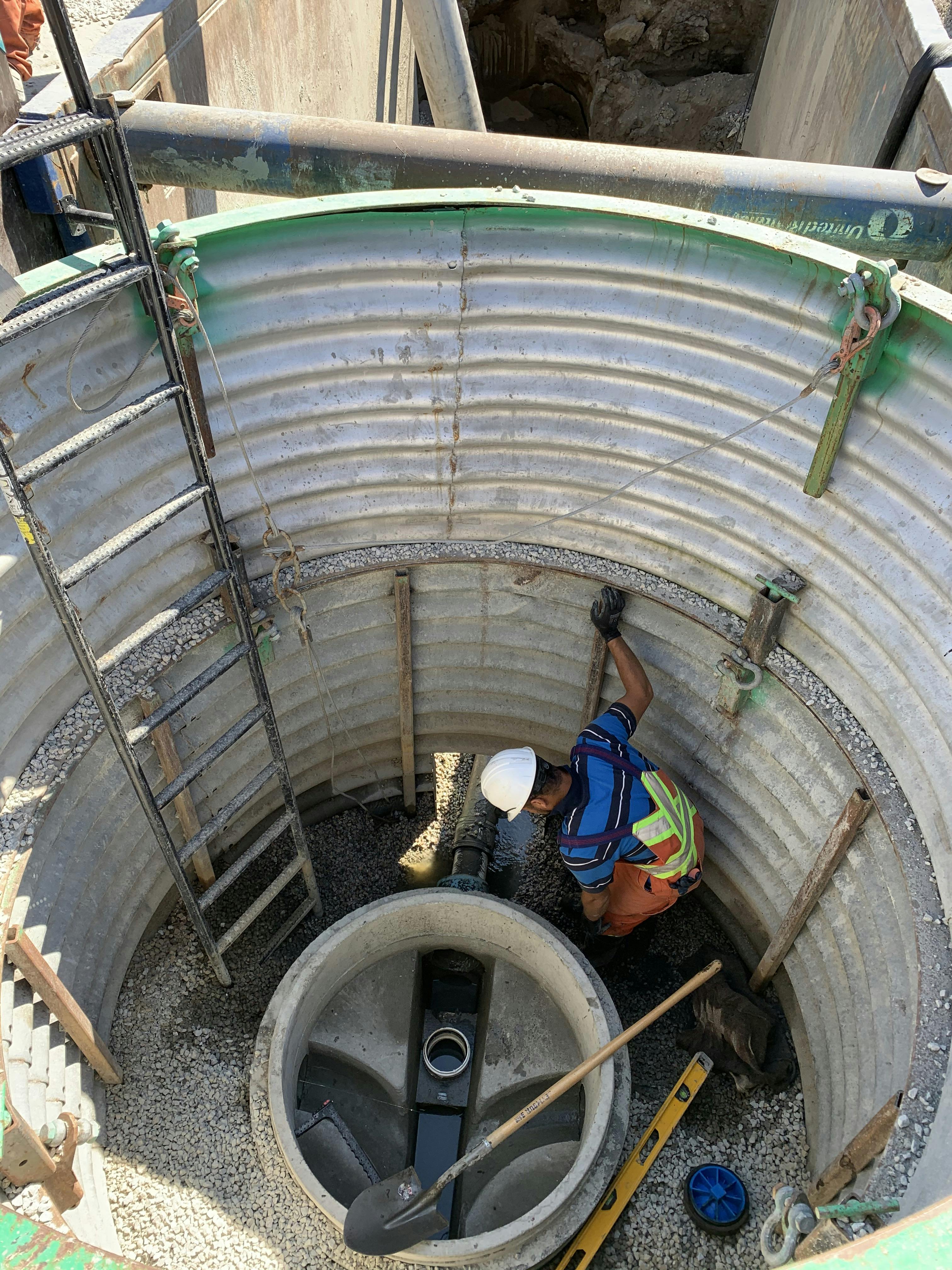 City worker installing a sanitary manhole